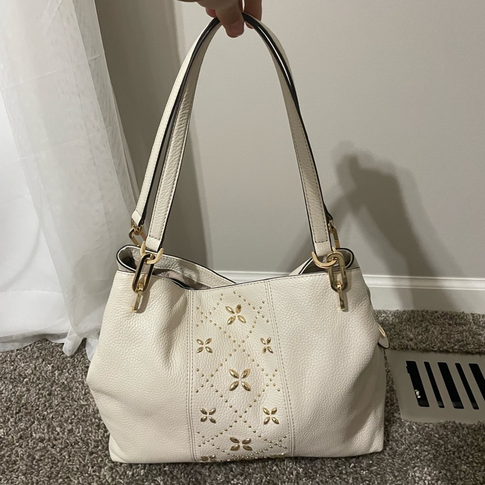 Michael Kors pebbled leather with floral pattern accent. White. Magnetic snap.